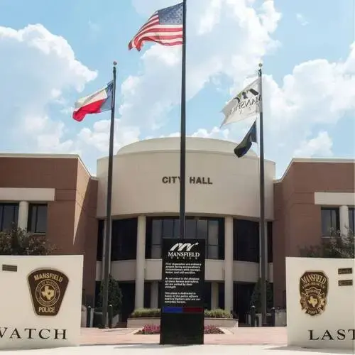 Mansfield City Hall building with American and Texas flags flying in front