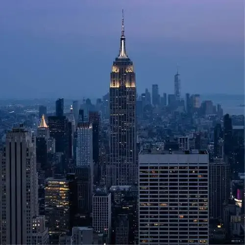 New York City skyline at dusk with the Empire State Building centered among surrounding skyscrapers