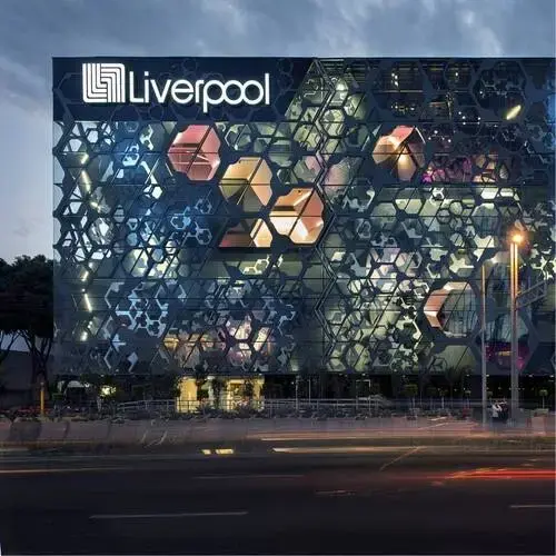Modern glass office building with a hexagonal patterned facade and a Liverpool sign at the top